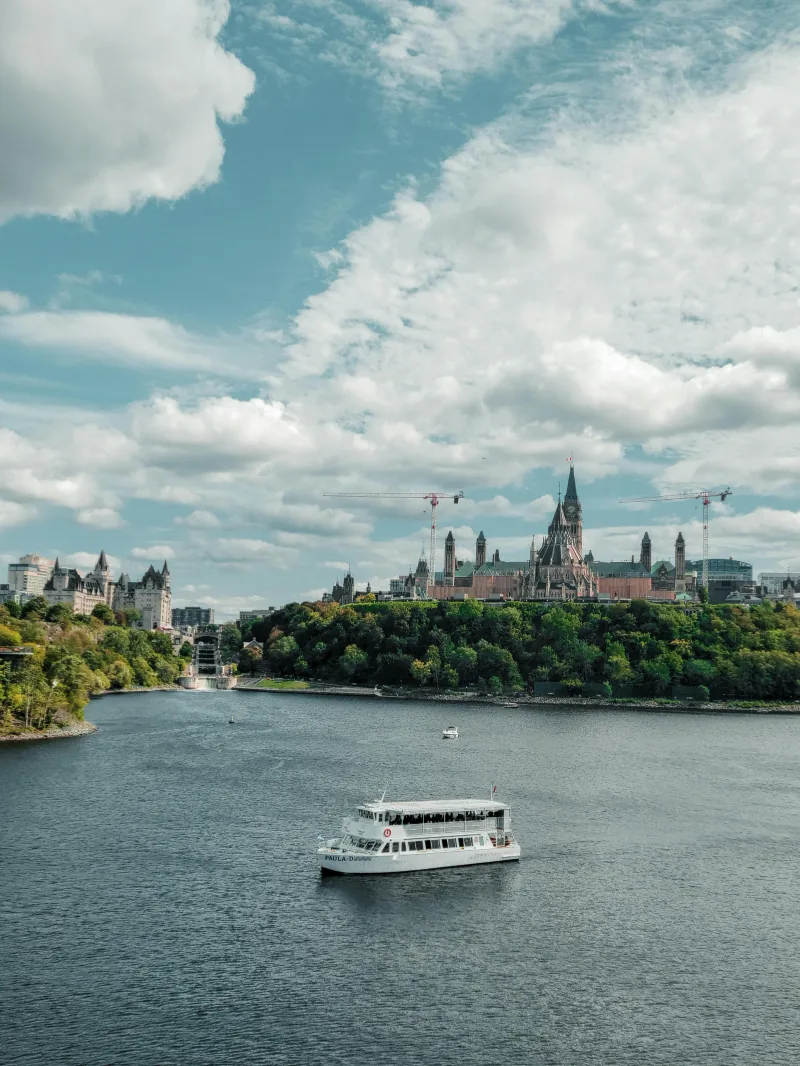 La Colline du Parlement surplombant la rivière des Outaouais, avec un bateau de promenade